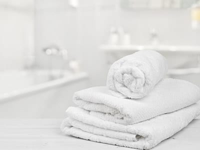 Stack of white towels in bathroom backdrop