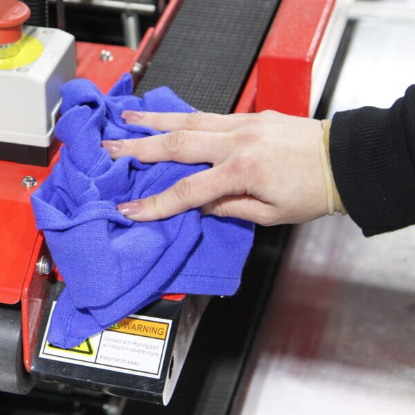 Woman using blue Huck Towel wiping down machinery