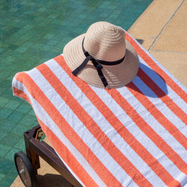 Orange Cabana Pool Towel on poolside chair