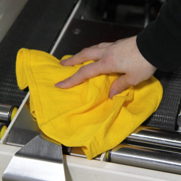 Woman using gold Huck Towel wiping down machinery