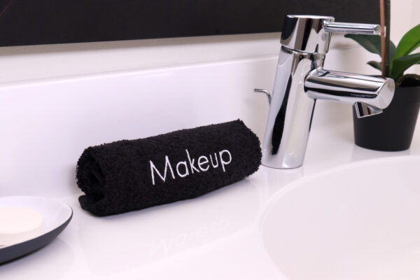 Makeup Towel rolled on bathroom sink counter