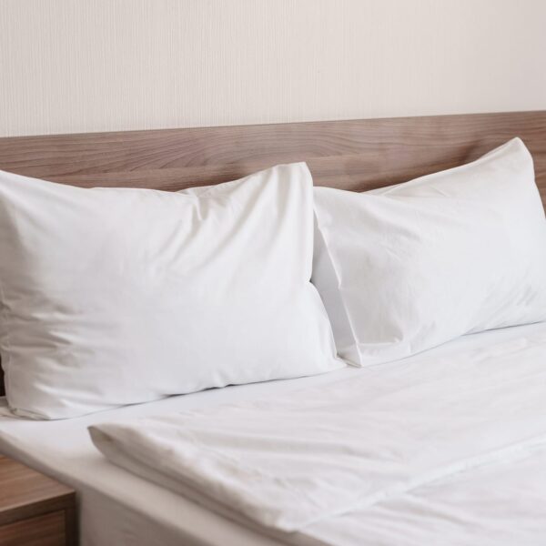 Bed with white linen pillows and bed