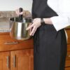 Waitress wearing black Poly Spun Aprons