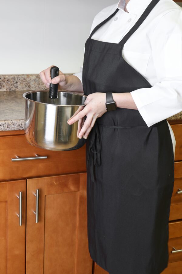 Waitress wearing black Poly Spun Aprons