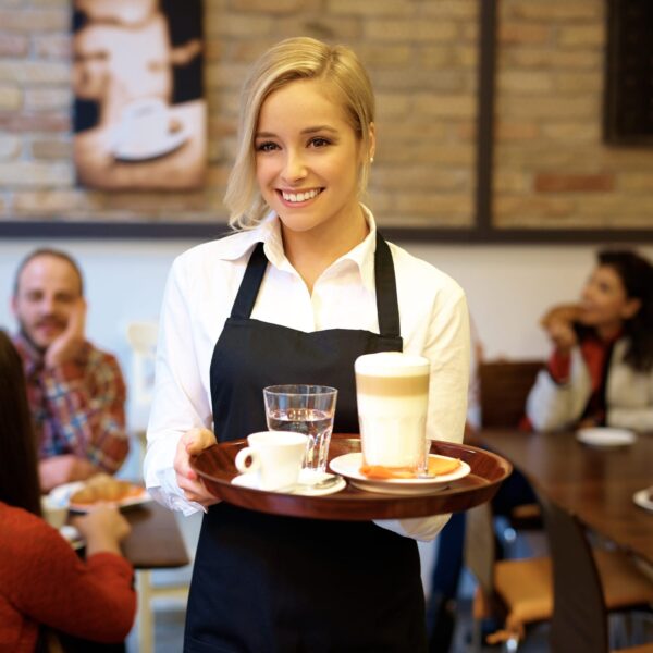 Waitress wearing black Poly Spun Aprons