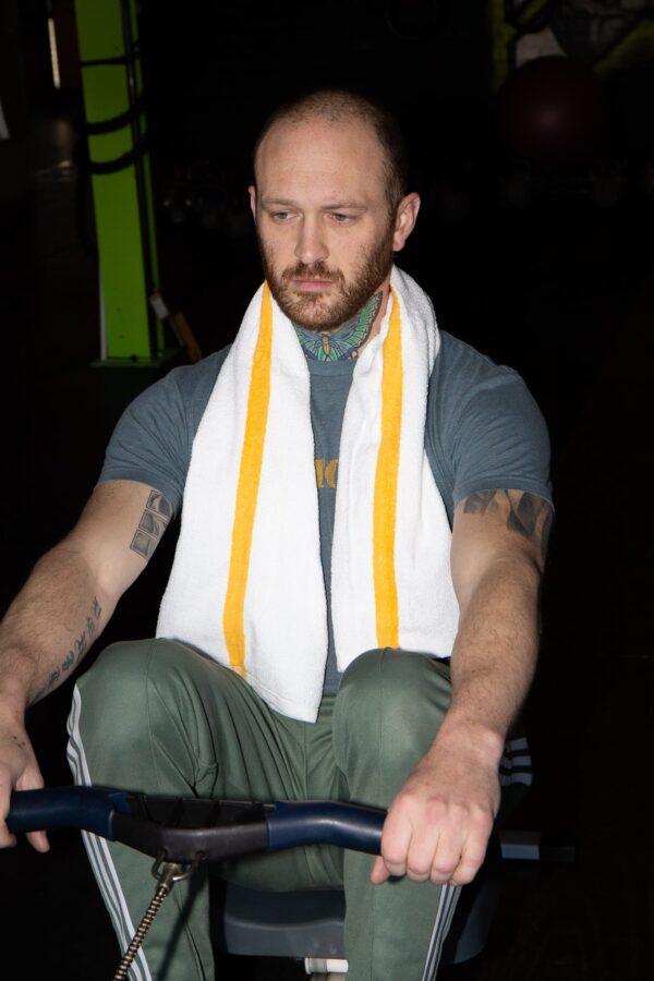 Man with Gym Towel with Gold Stripe around neck