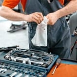 Mechanic wiping down tools with cloth