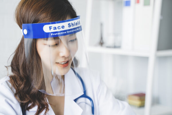 Medical healthcare Asian doctor wearing face shield mask protection