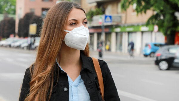 Woman in city street wearing KN95 FFP2 mask