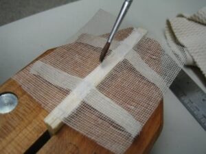 Glue being brushed on book spine