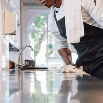 Bartender using Monarch Brands Bar Mops to clean counter