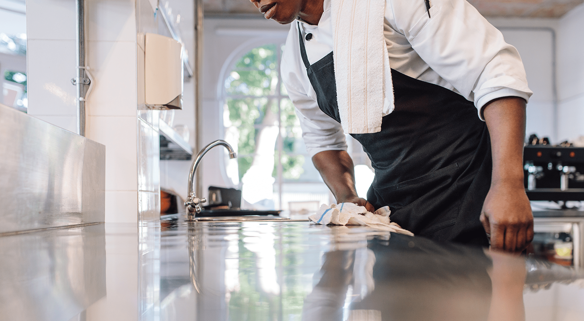 Bartender using Monarch Brands Bar Mops to clean counter