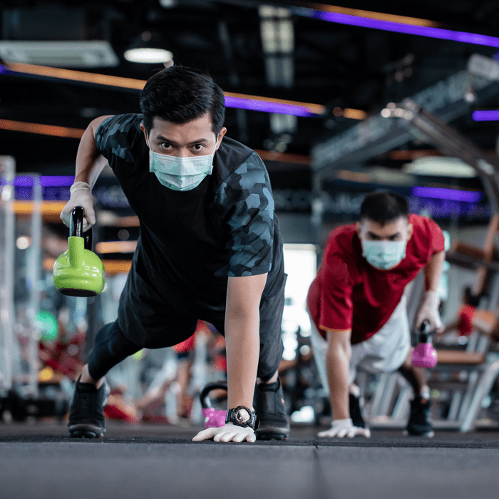 Men wearing PPE masks exercising