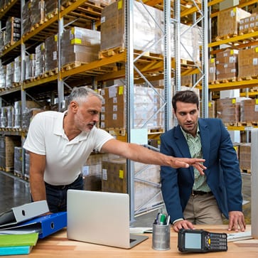 Warehouse workers having meeting in warehouse