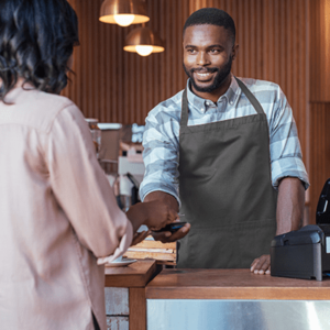 Customer paying a barista for her purchase with NFC technology